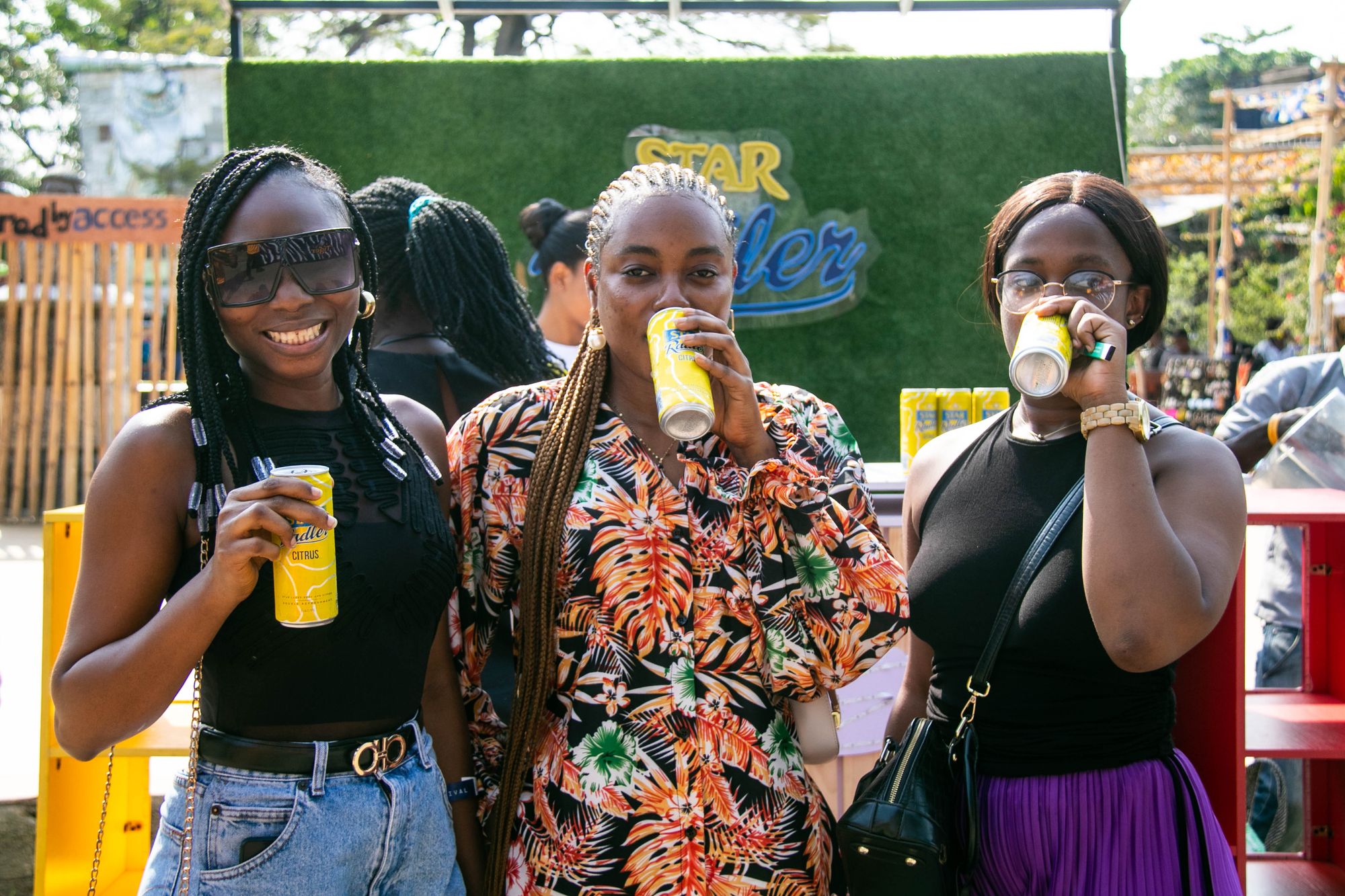 Three women sipping cans of Star Radler at the first edition of Alté Culture Festival